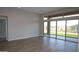 An expansive living room showcasing a wall of sliding glass doors offering scenic backyard views at 32513 N 135Th Dr, Peoria, AZ 85383
