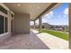 Spacious covered patio with desert landscaping and a wrought iron fence surrounding the backyard at 32513 N 135Th Dr, Peoria, AZ 85383
