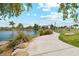 Picturesque view of community park featuring walking path, shade structure, open grassy space and community lake at 1676 N Camden Dr, Florence, AZ 85132