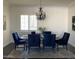 Bright dining room featuring dark upholstered chairs, shuttered windows, a chandelier and neutral area rug at 3076 E La Costa Dr, Gilbert, AZ 85298
