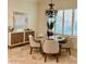 Cozy dining room with shuttered windows and travertine floors, featuring a round table and modern buffet at 3076 E La Costa Dr, Gilbert, AZ 85298