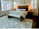 Bright main bedroom with shuttered windows, stylish lamps, an upholstered headboard and an area rug at 3076 E La Costa Dr, Gilbert, AZ 85298