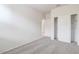 Bright bedroom featuring neutral walls, carpet, and a closet with sliding doors at 38120 W Excussare Way, Maricopa, AZ 85138