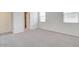 Large bedroom showcasing neutral carpet, white walls, and a bright window at 38120 W Excussare Way, Maricopa, AZ 85138