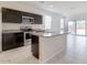 Bright, spacious kitchen with a large island, stainless steel appliances, and dark wood cabinets at 38120 W Excussare Way, Maricopa, AZ 85138