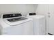 A dedicated laundry room with a white washer and dryer set at 38120 W Excussare Way, Maricopa, AZ 85138