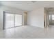 Spacious living area with tile flooring, a sliding glass door, and plenty of natural light at 38120 W Excussare Way, Maricopa, AZ 85138