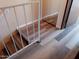 Hallway with stairs and metal railing leads to other level of home with mirror door at 4630 N 68Th St # 248, Scottsdale, AZ 85251