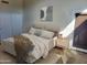 Cozy bedroom with a comfortable bed, closet, and a view of the outdoors through a glass door at 1523 E Black Diamond Dr, Gilbert, AZ 85296
