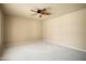 Bright bedroom with beige carpet and a ceiling fan at 2606 N 159Th Dr, Goodyear, AZ 85395