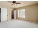 Bright bedroom with ceiling fan, closet and window with shutter at 2606 N 159Th Dr, Goodyear, AZ 85395