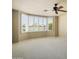Bedroom featuring large bay window, ceiling fan, and neutral carpeting at 2606 N 159Th Dr, Goodyear, AZ 85395