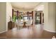 Elegant dining room featuring a chandelier, bay windows with curtains, and a stylish table with white chairs at 2606 N 159Th Dr, Goodyear, AZ 85395