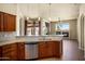 Kitchen boasts granite countertops, stainless steel dishwasher and appliances, with a view to the living room at 2606 N 159Th Dr, Goodyear, AZ 85395