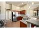 Granite countertops, stainless steel refrigerator, and pendant lighting highlight this kitchen at 2606 N 159Th Dr, Goodyear, AZ 85395