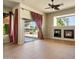 Open concept living room featuring a fireplace, a sliding glass door and tile flooring, for seamless indoor-outdoor living at 2606 N 159Th Dr, Goodyear, AZ 85395