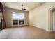 Bright living room with fireplace, ceiling fan and tile flooring, perfect for entertaining guests or relaxing at 2606 N 159Th Dr, Goodyear, AZ 85395