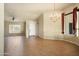 Spacious living room featuring a decorative chandelier, neutral walls and tiled floors, enhancing its appeal at 2606 N 159Th Dr, Goodyear, AZ 85395