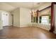 Bright living room with tile flooring, a bay window, and a stylish chandelier creating an inviting ambiance at 2606 N 159Th Dr, Goodyear, AZ 85395