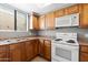 Well-lit kitchen with light wood cabinets, updated appliances, and a stainless steel double sink at 4925 E Desert Cove Ave # 350, Scottsdale, AZ 85254