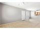 Cozy living room with plush carpeting, a front door, and views into the kitchen at 4925 E Desert Cove Ave # 350, Scottsdale, AZ 85254