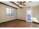 Simple and bright bedroom featuring neutral walls, terracotta tile, and a door leading to the outside at 1346 W Willetta St, Phoenix, AZ 85007