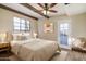 Comfortable bedroom featuring a cozy bed, soft lighting, and door leading to the outside at 1346 W Willetta St, Phoenix, AZ 85007