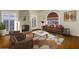 Bright living room featuring hardwood floors, a stylish sofa, and a decorative fireplace at 1346 W Willetta St, Phoenix, AZ 85007