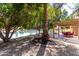 Backyard with mature trees, covered patio, and views of the lake at 2107 S Paseo Loma --, Mesa, AZ 85202