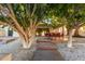 Relaxing backyard with a covered patio, outdoor dining area, and lush landscaping, perfect for entertaining at 2107 S Paseo Loma --, Mesa, AZ 85202