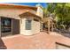 Exterior view of a home featuring a covered patio and well-maintained brick landscaping at 2107 S Paseo Loma --, Mesa, AZ 85202