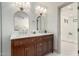 Modern bathroom featuring a double sink vanity, gold fixtures, and a separate shower room at 2107 S Paseo Loma --, Mesa, AZ 85202