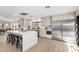 Modern kitchen with stainless steel appliances, a center island with seating, and bright lighting at 2107 S Paseo Loma --, Mesa, AZ 85202