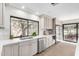 Well-lit kitchen with stainless steel appliances, a double sink, and a view of the backyard at 2107 S Paseo Loma --, Mesa, AZ 85202