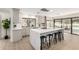 Bright kitchen featuring white cabinets, a large island with seating, and sliding glass doors to the outdoor patio at 2107 S Paseo Loma --, Mesa, AZ 85202