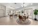 Open-concept living area with a dining space featuring light wood floors and abundant natural light at 2107 S Paseo Loma --, Mesa, AZ 85202