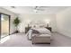 Relaxing main bedroom featuring neutral colors, a ceiling fan, and sliding glass doors to the backyard at 2107 S Paseo Loma --, Mesa, AZ 85202