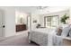 Light-filled main bedroom with a bathroom ensuite, a water view, and a ceiling fan at 2107 S Paseo Loma --, Mesa, AZ 85202