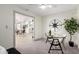 Home office with a glass desk, compass decoration, and a view into the dining room and kitchen at 2107 S Paseo Loma --, Mesa, AZ 85202