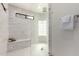 Luxurious walk-in shower with sleek glass enclosure, bench, and modern tile design at 2107 S Paseo Loma --, Mesa, AZ 85202