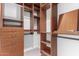 Spacious walk-in closet with custom built-in shelving and drawers for optimal organization at 2107 S Paseo Loma --, Mesa, AZ 85202
