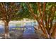 Picturesque waterfront view featuring a wooden walkway leading to the water, framed by lush trees and greenery at 2107 S Paseo Loma --, Mesa, AZ 85202