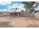 Home's back elevation with covered patio and spacious yard at 6010 W Lewis Ave, Phoenix, AZ 85035