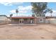 Home's back elevation with covered patio and spacious yard at 6010 W Lewis Ave, Phoenix, AZ 85035