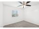 Simple bedroom with ceiling fan and window blinds at 6010 W Lewis Ave, Phoenix, AZ 85035