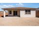 The backyard includes a covered patio and low block wall with a large sliding glass door to the interior at 16923 W Siesta Way, Goodyear, AZ 85338