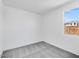 Bright bedroom has neutral gray carpet and a large single window at 16923 W Siesta Way, Goodyear, AZ 85338