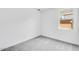 Bright bedroom has neutral gray carpet and a large single window at 16923 W Siesta Way, Goodyear, AZ 85338