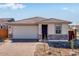 Charming single-story home featuring a brick driveway, attached garage, and inviting entrance at 16923 W Siesta Way, Goodyear, AZ 85338