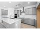 Modern kitchen featuring stainless steel appliances, white countertops, and gray shaker-style cabinets at 16923 W Siesta Way, Goodyear, AZ 85338